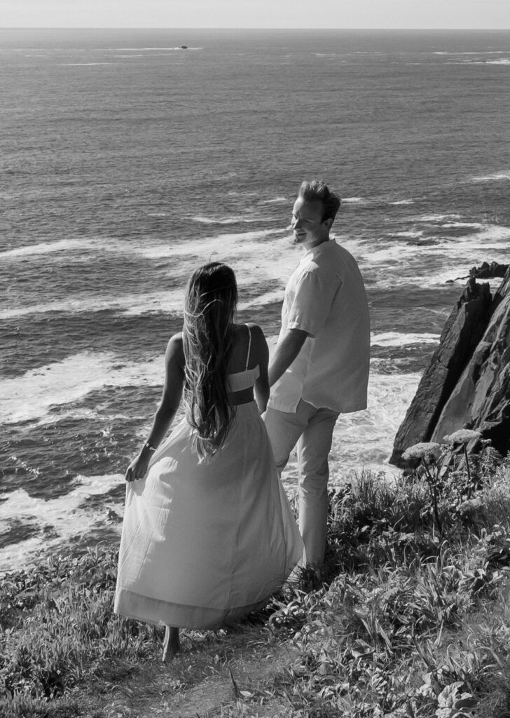 A photo of a couple looking out over the Oregon coast that just celebrating their elopement. Photo was taken by Kollar Photography. Arizona Elopement Photographer