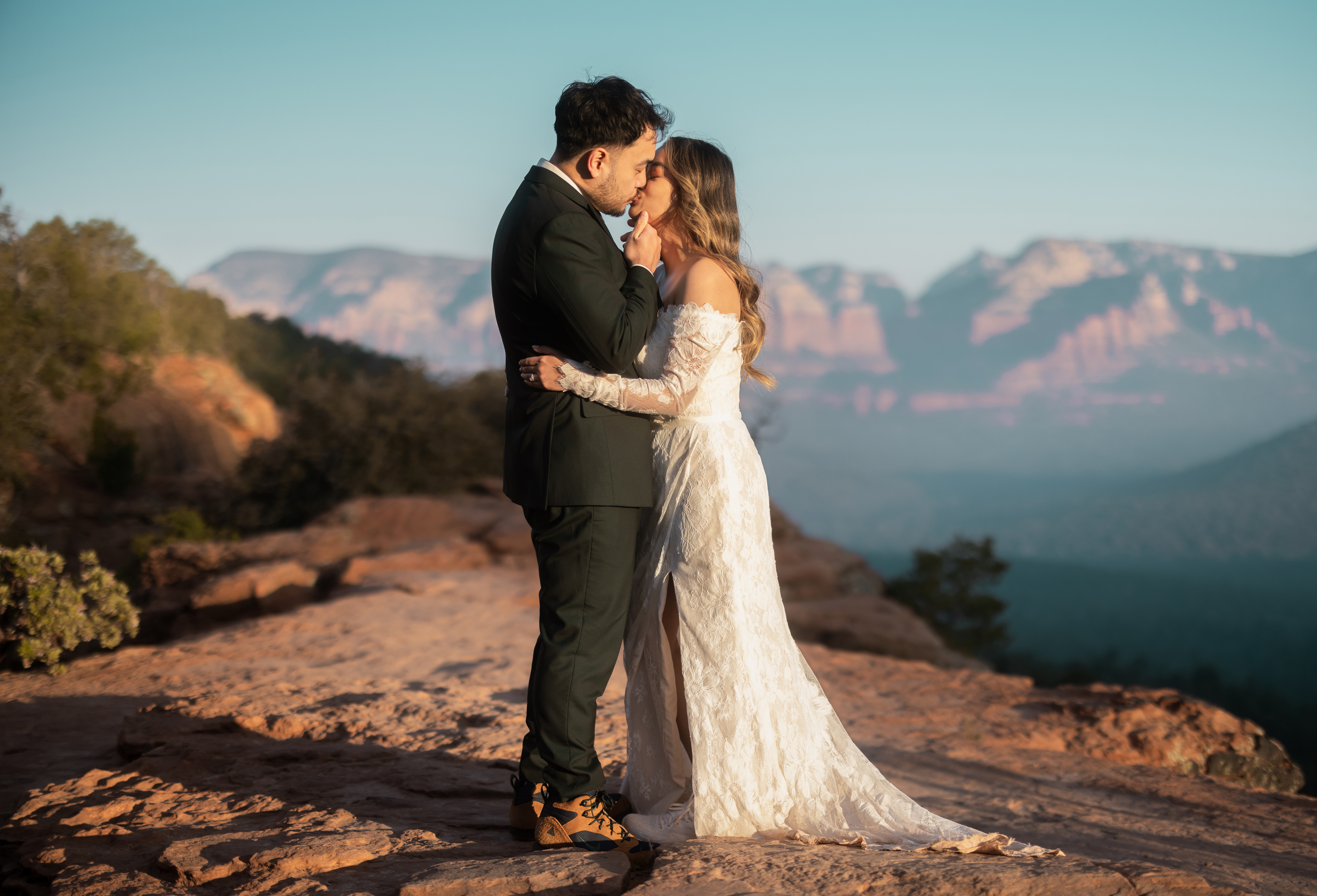 A bride and groom share a kiss on Devils bridge in Sedona on their Elopement. Photo taken by Kollar Photography. Arizona Elopement Photographer