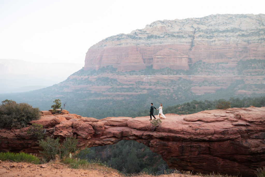 Adventurous couple standing on Devil's Bridge during their Sedona elopement.