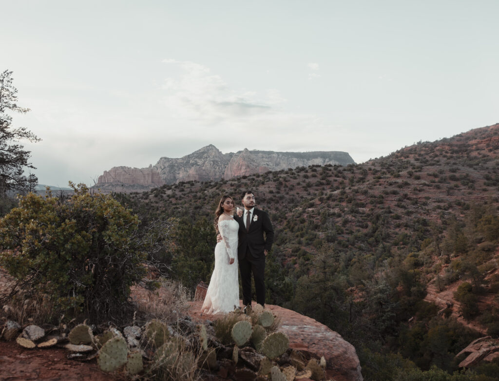 Couple walking through a shaded forest trail during their fall Sedona elopement.