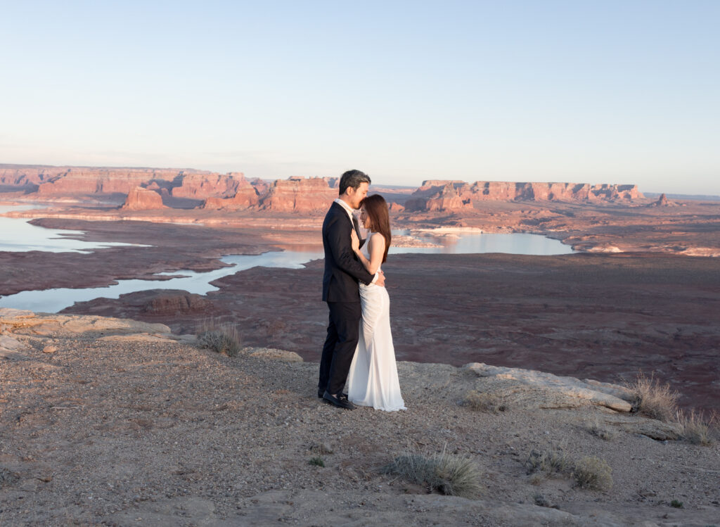 Golden-hour portraits by the lake with soft reflections on the water, desert grasses in the breeze, and smiles that say “we did it.”