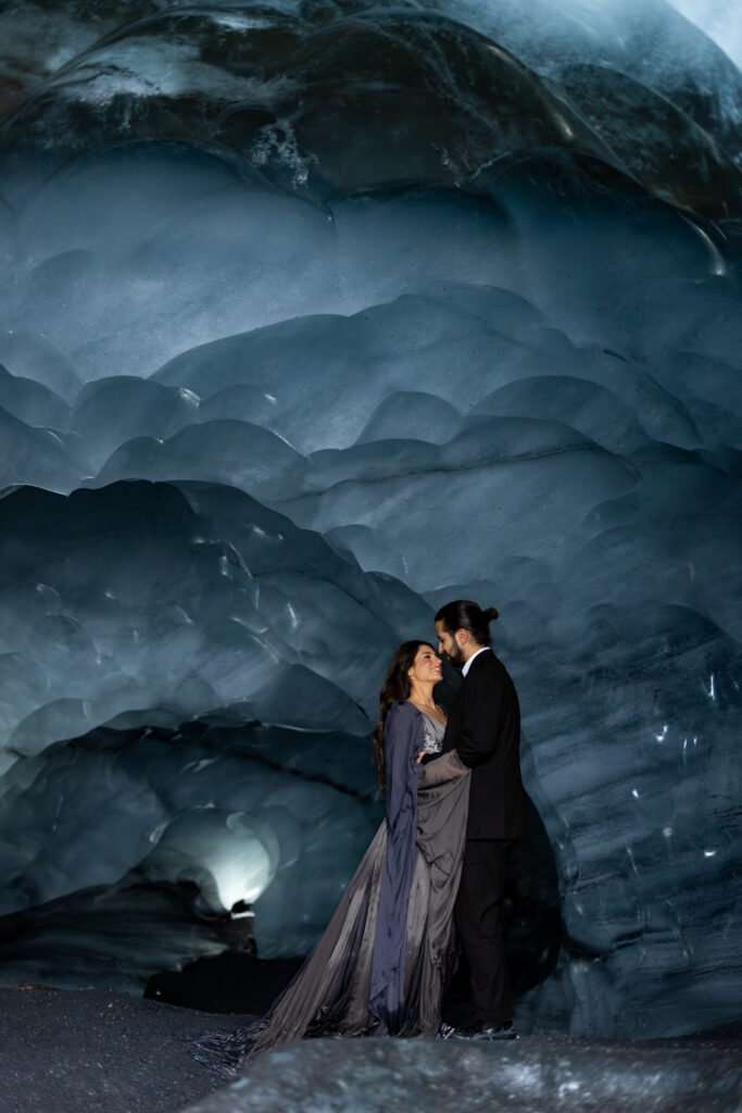 A couple eloping in an ice cave on a glacier near Vik, Iceland. A photo by Kollar photography.