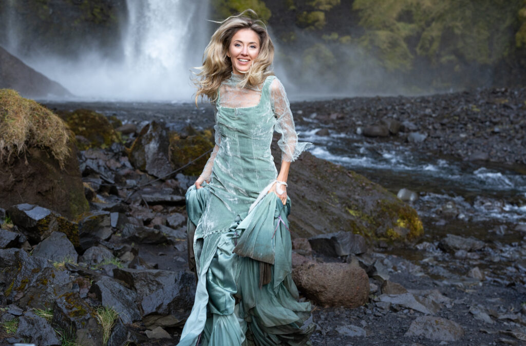 Bride in blue wedding dress exploring Iceland’s South Coast during an adventure elopement