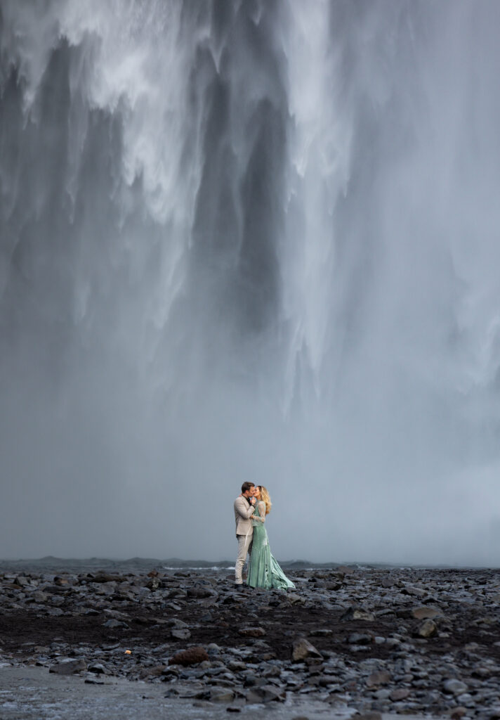Iceland elopement photographer capturing bride and groom at Skógafoss waterfall