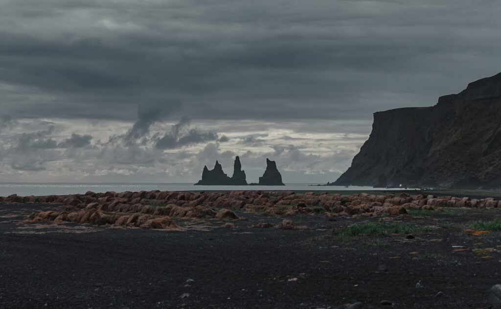South Coast view of Reynisdrangar sea stacks from black sand cliffs | Kollar Photography
