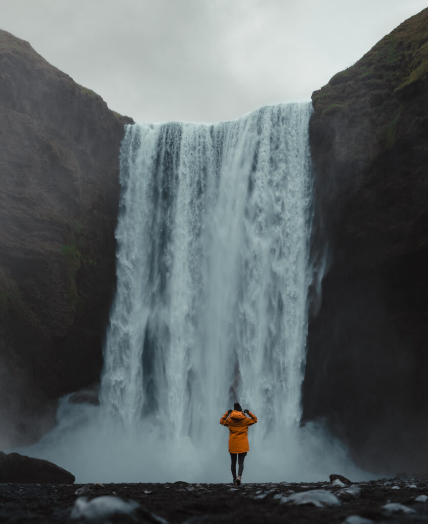 Iceland elopement photographer capturing bride and groom at Skógafoss waterfall